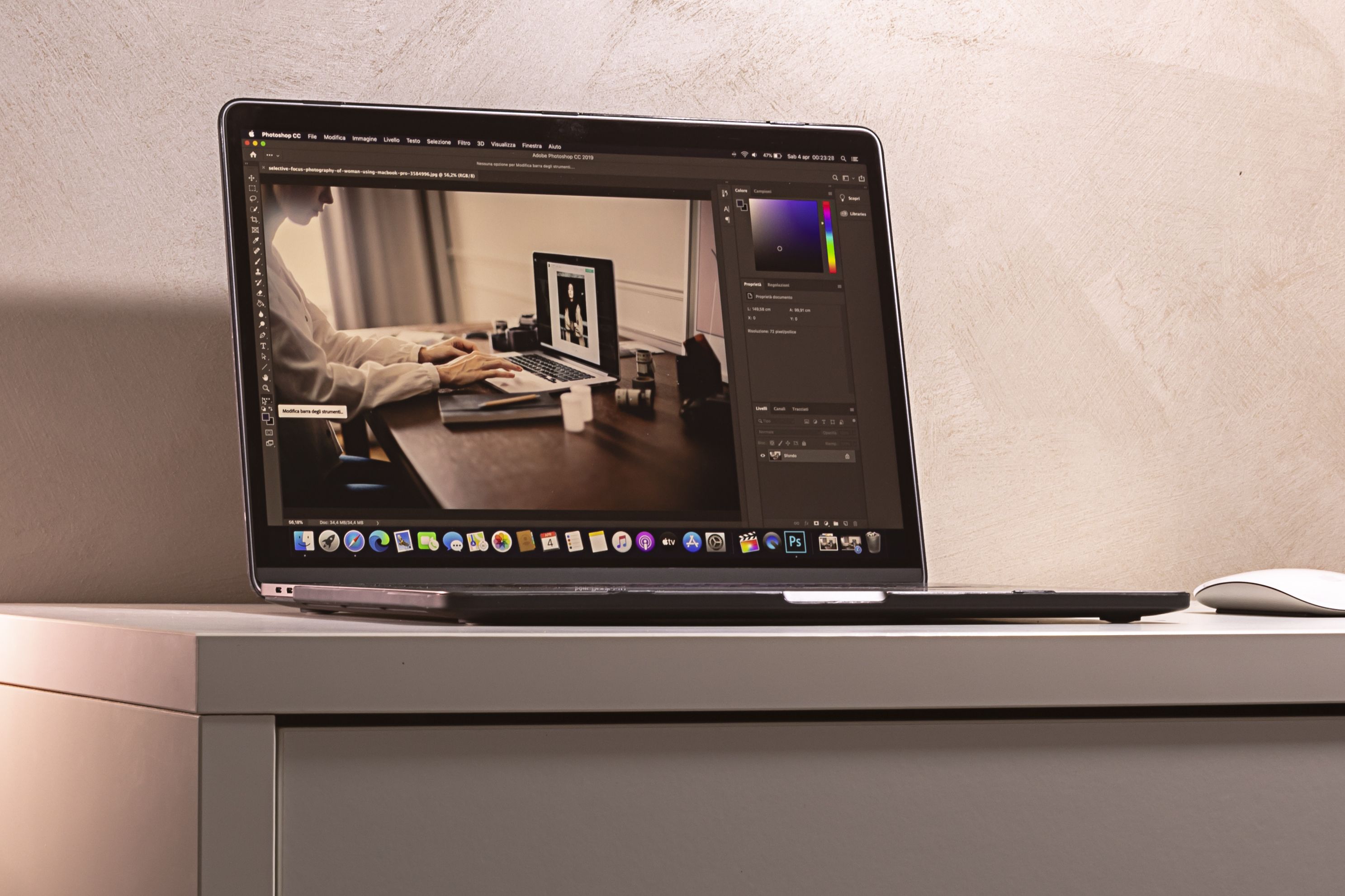 Laptop displaying photo editing software for compressing website images