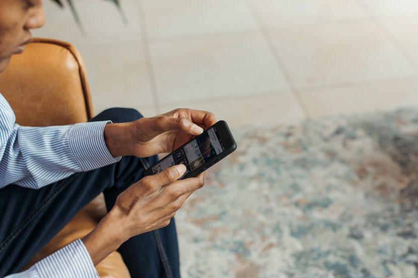 Person browsing a website on a smartphone checking mobile load speed