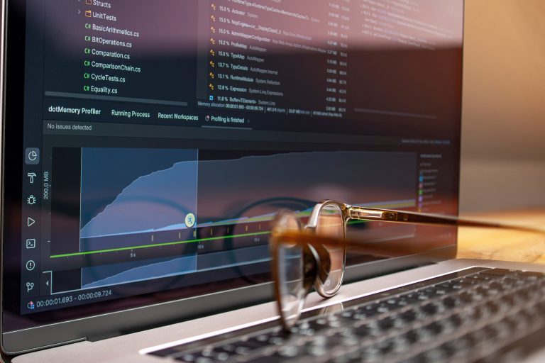 Laptop screen showing code and performance graphs used to test website speed